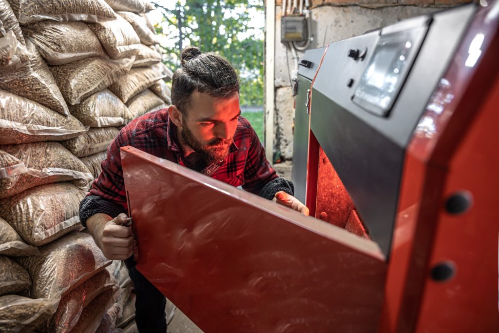 man looking into biomass boiler