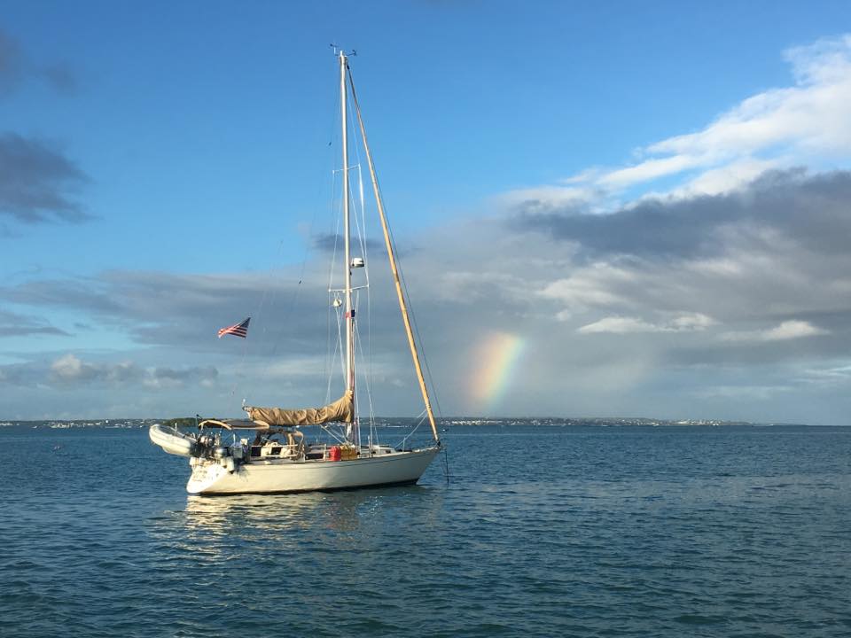 Calico Skies Sailboat in the Ocean with a Rainbow