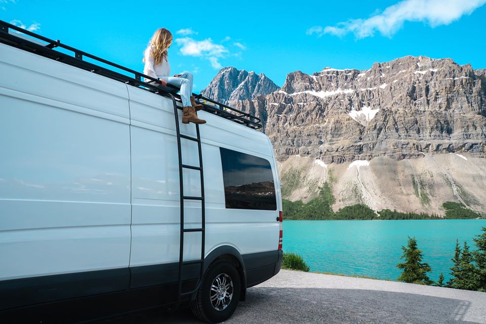 Sara James on a Camper Van by Water and Mountains