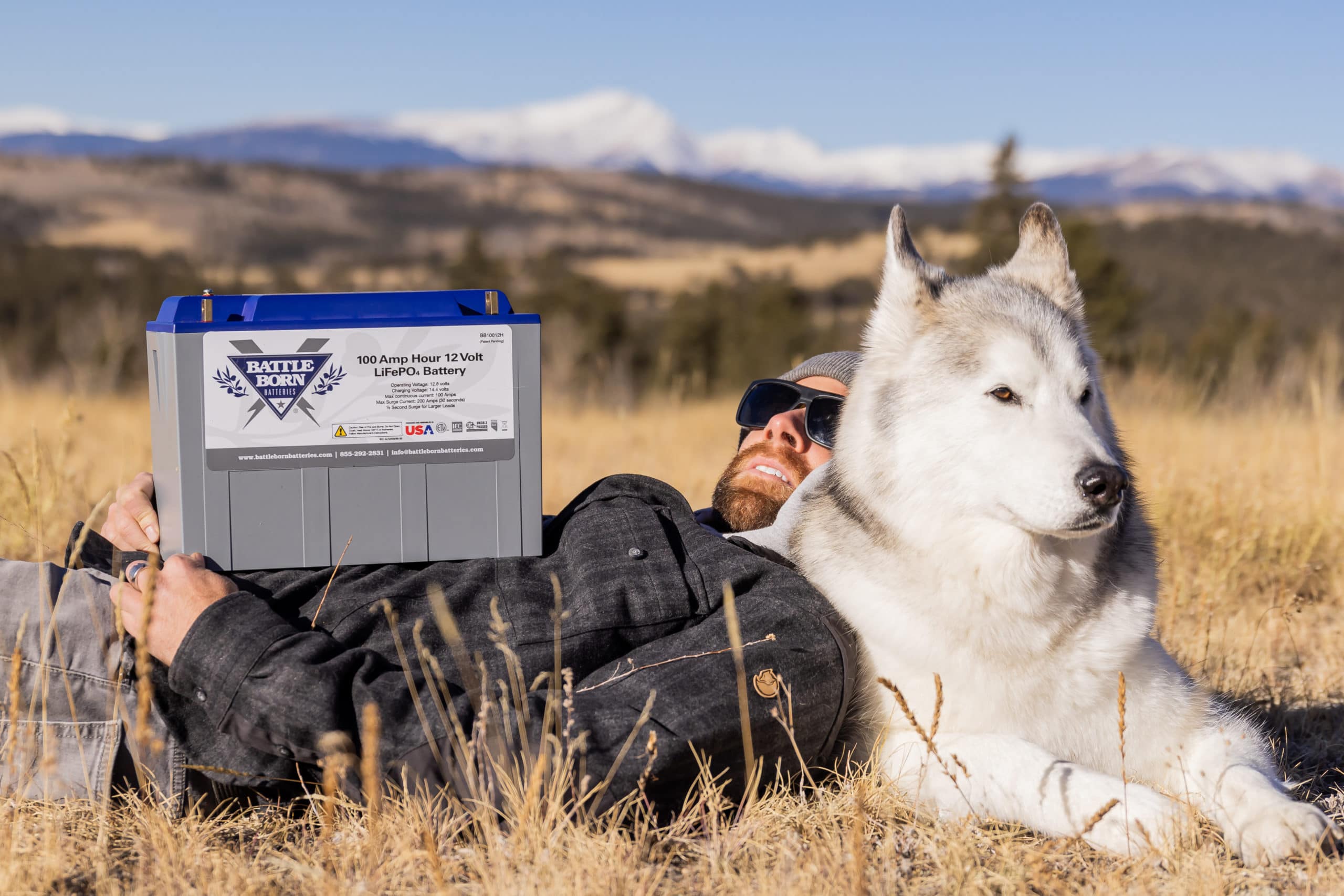 Loki the Wolfdog and Kelly Lund with a Battle Born Battery