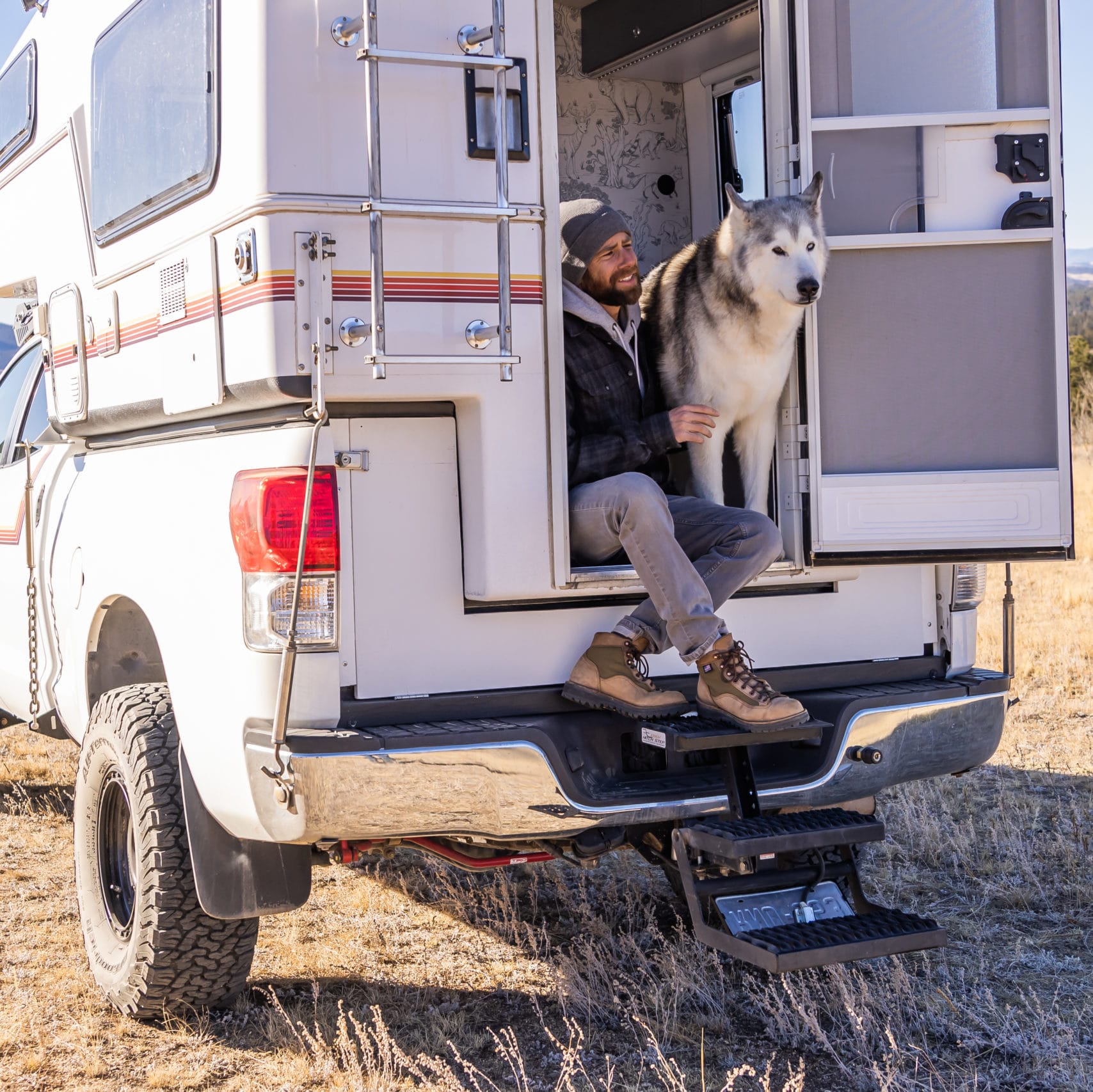 Loki the Wolfdog and Kelly Lund' in their Truck Camper