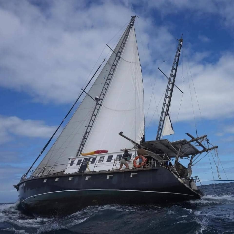 expedition drenched sailboat leaning to one side