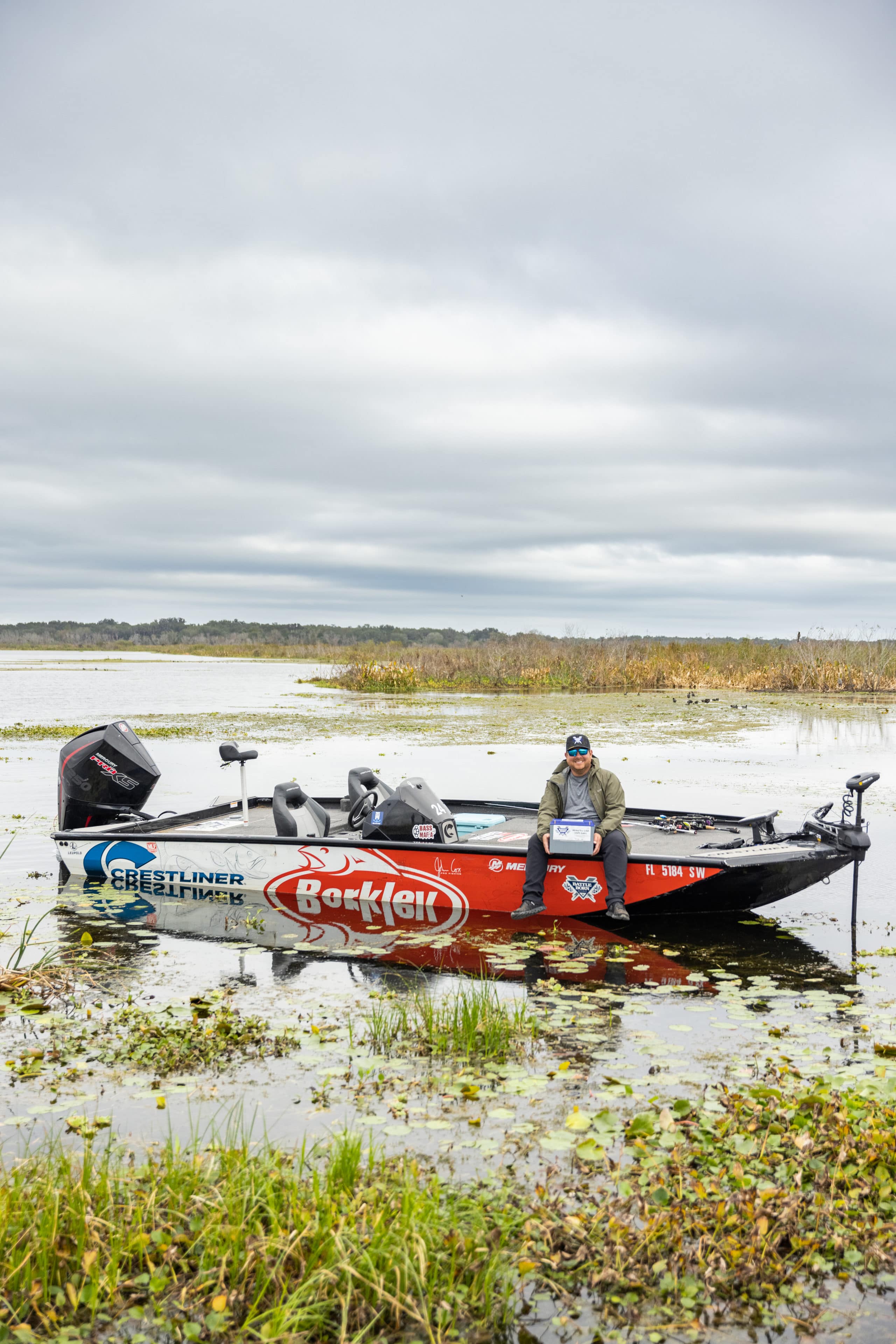 Professional Angler John Cox Fishing On His Bass Boat Holding a Battle Born Battery