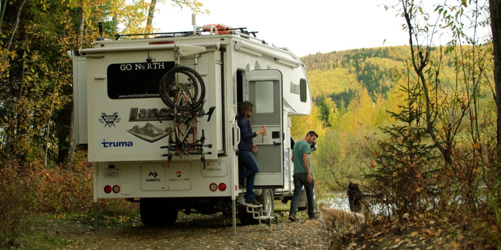 couple boondocking in alaska with truck camper