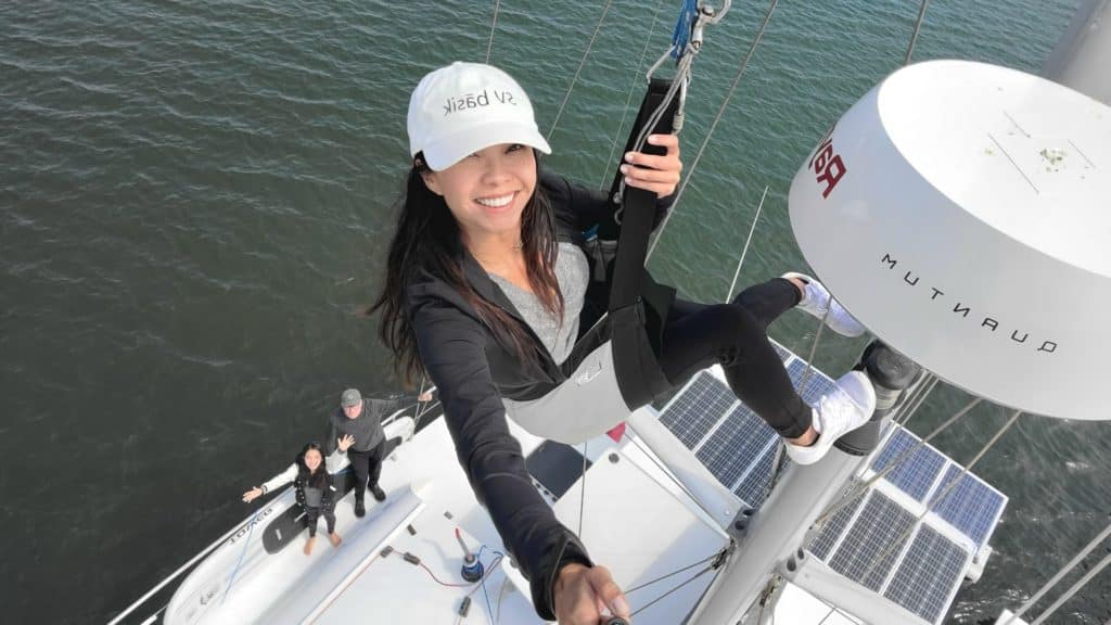 woman on sailboat mast