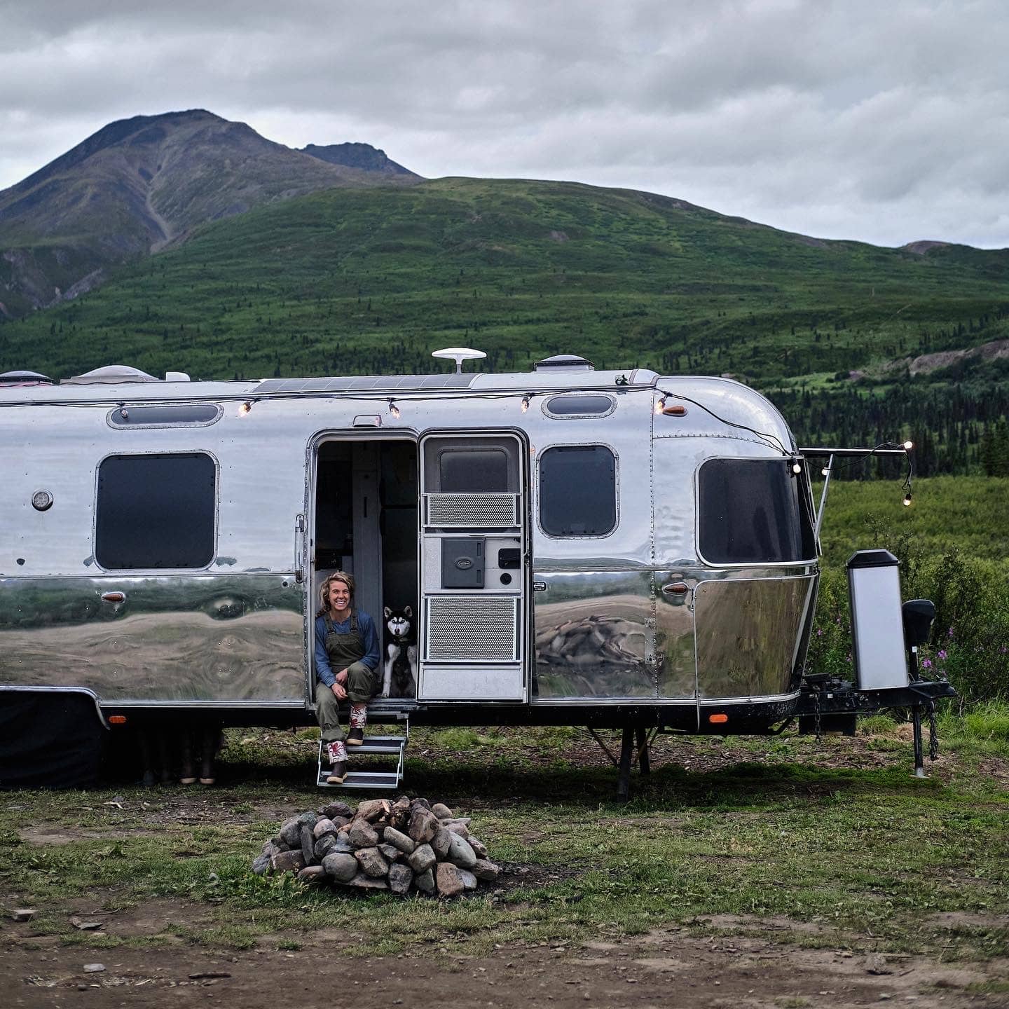 Kendall Strachan and Her Puppy in the Doorway of Their Airstream in Alaska