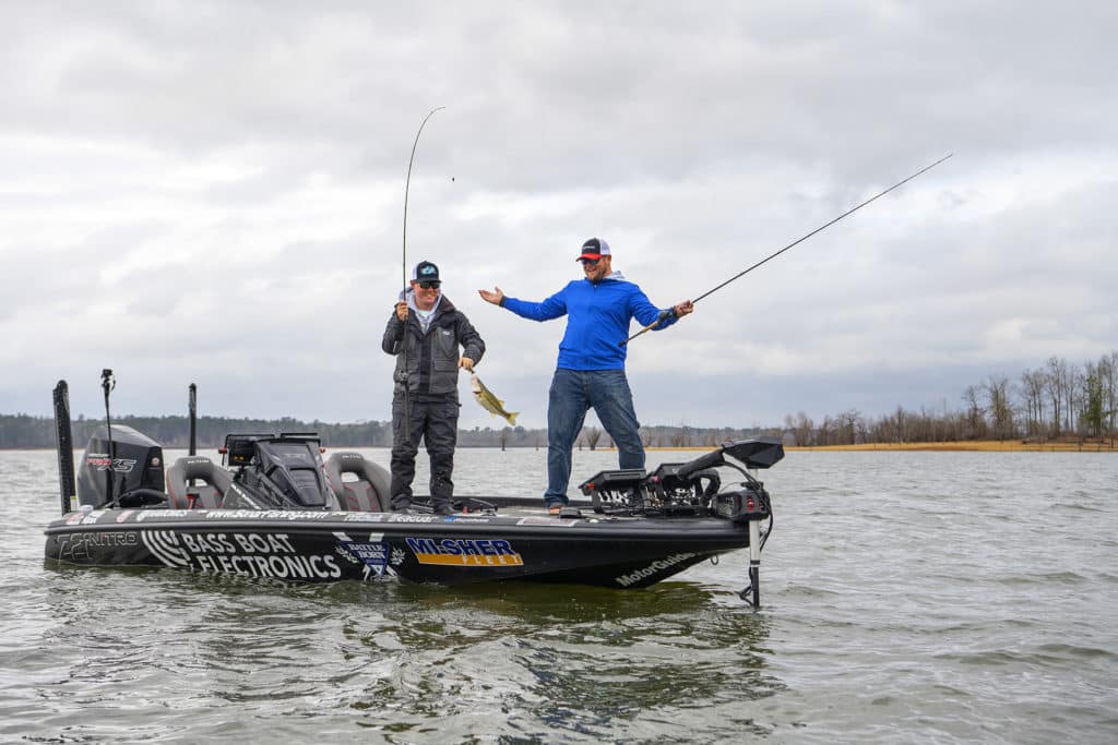 Two men fishing off of a bass boat that is powered by Battle Born Batteries