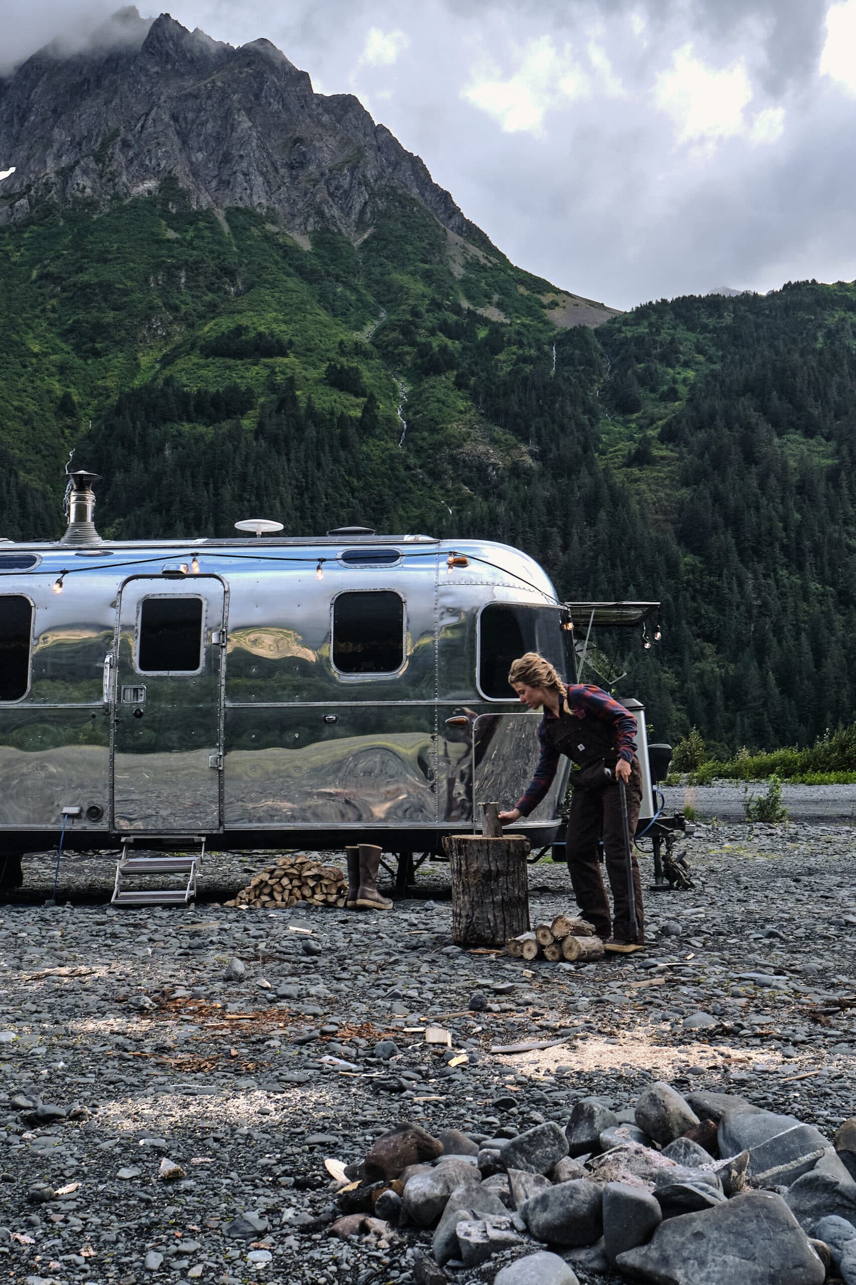 Kendall Strachan Chopping Wood in Front of Her Renovated Airstream in Alaska