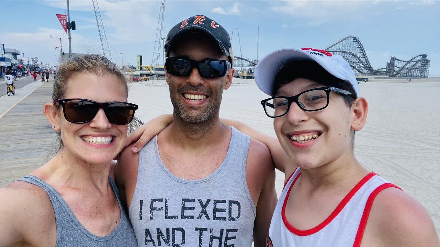 Endless RVing family in front of a boardwalk