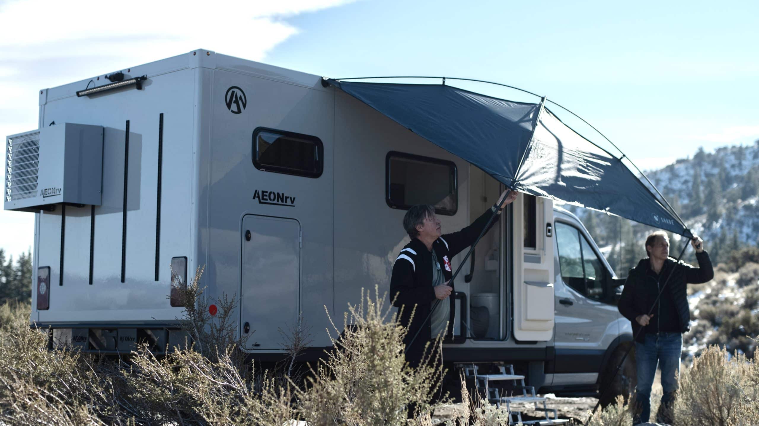 men opening up the awning on their AEONrv