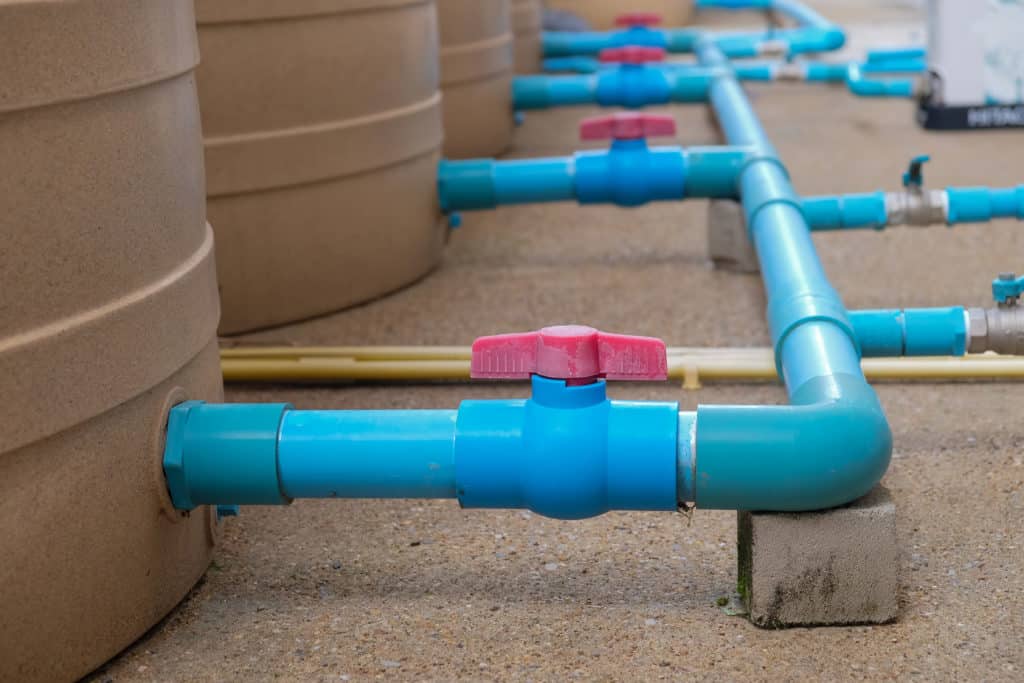 blue pipes leading to water tanks