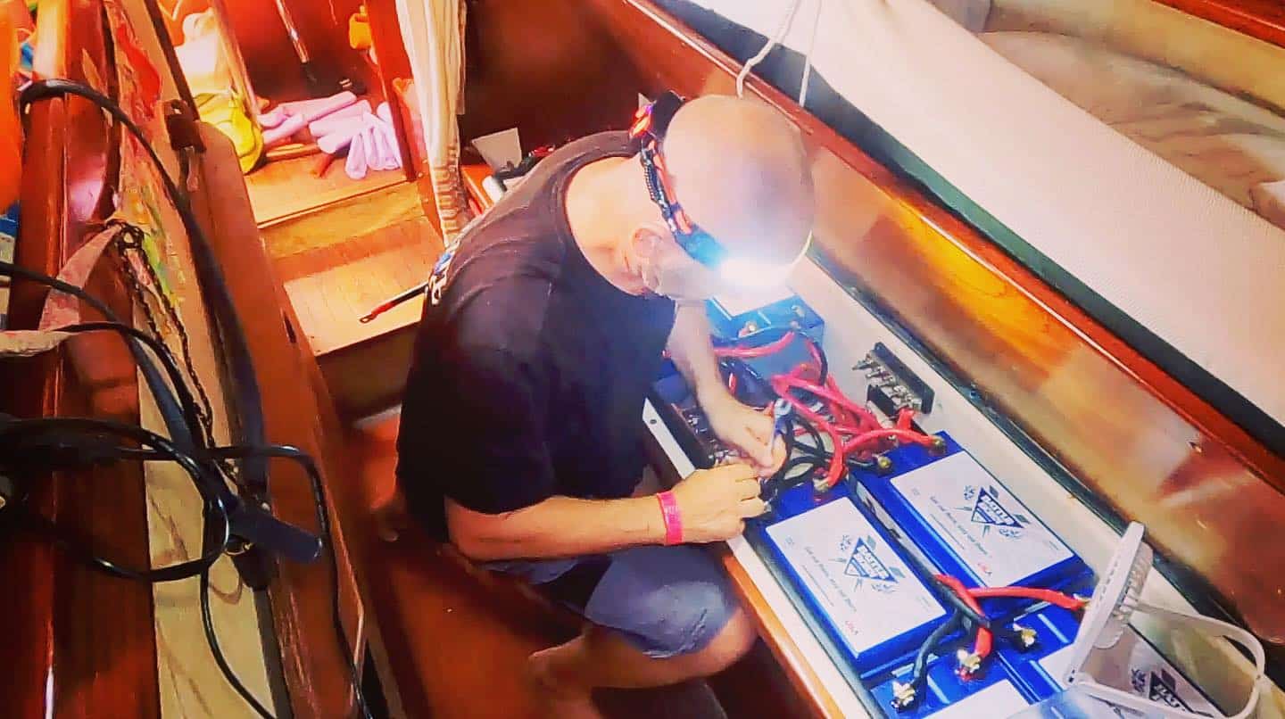 Woody wearing a headlamp while installing Battle Born Batteries