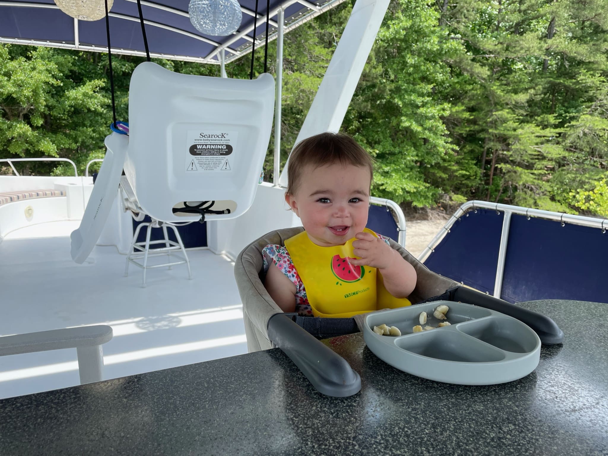Clare Kitchens eating a snack on the deck of her houseboat