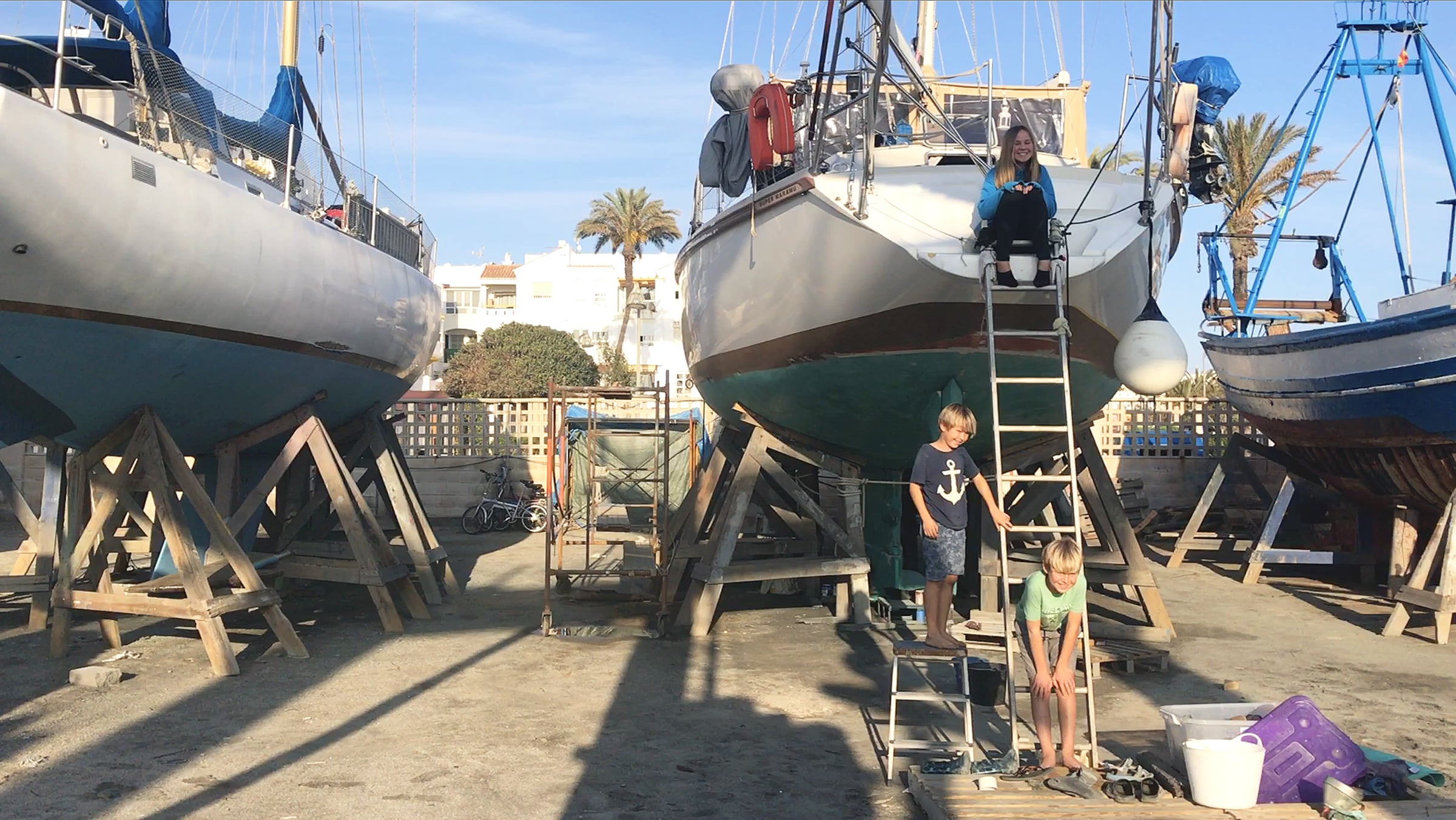 Rowan, Darry, and Yewan on a sailboat out of water