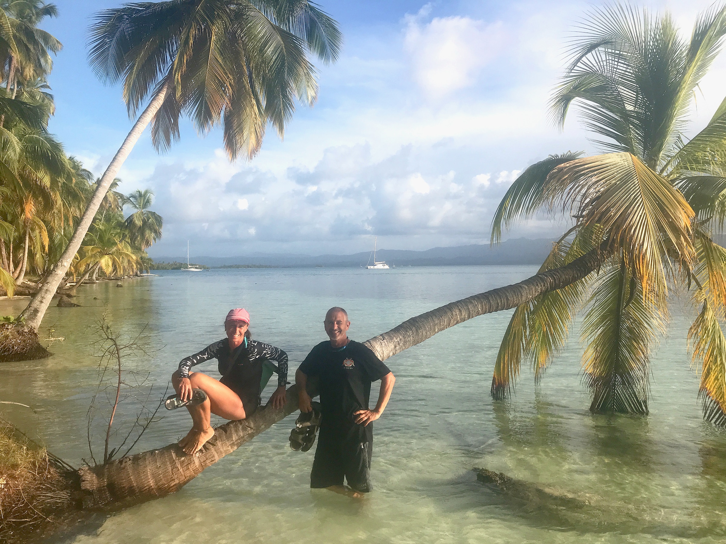 Irenka and Woody Standing next to a palm tree in water