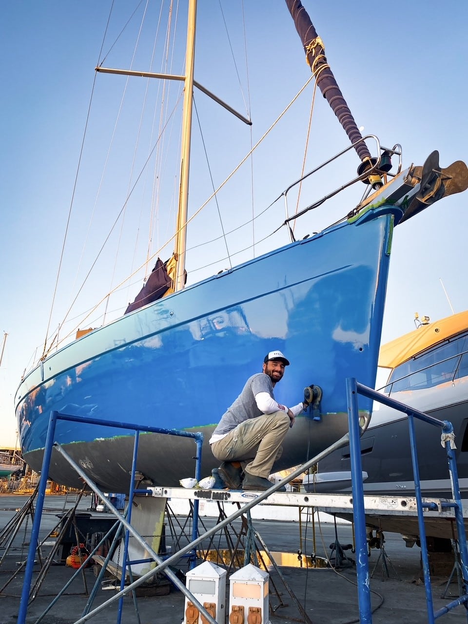 Raf Echemndia sanding the hull of his sailboat