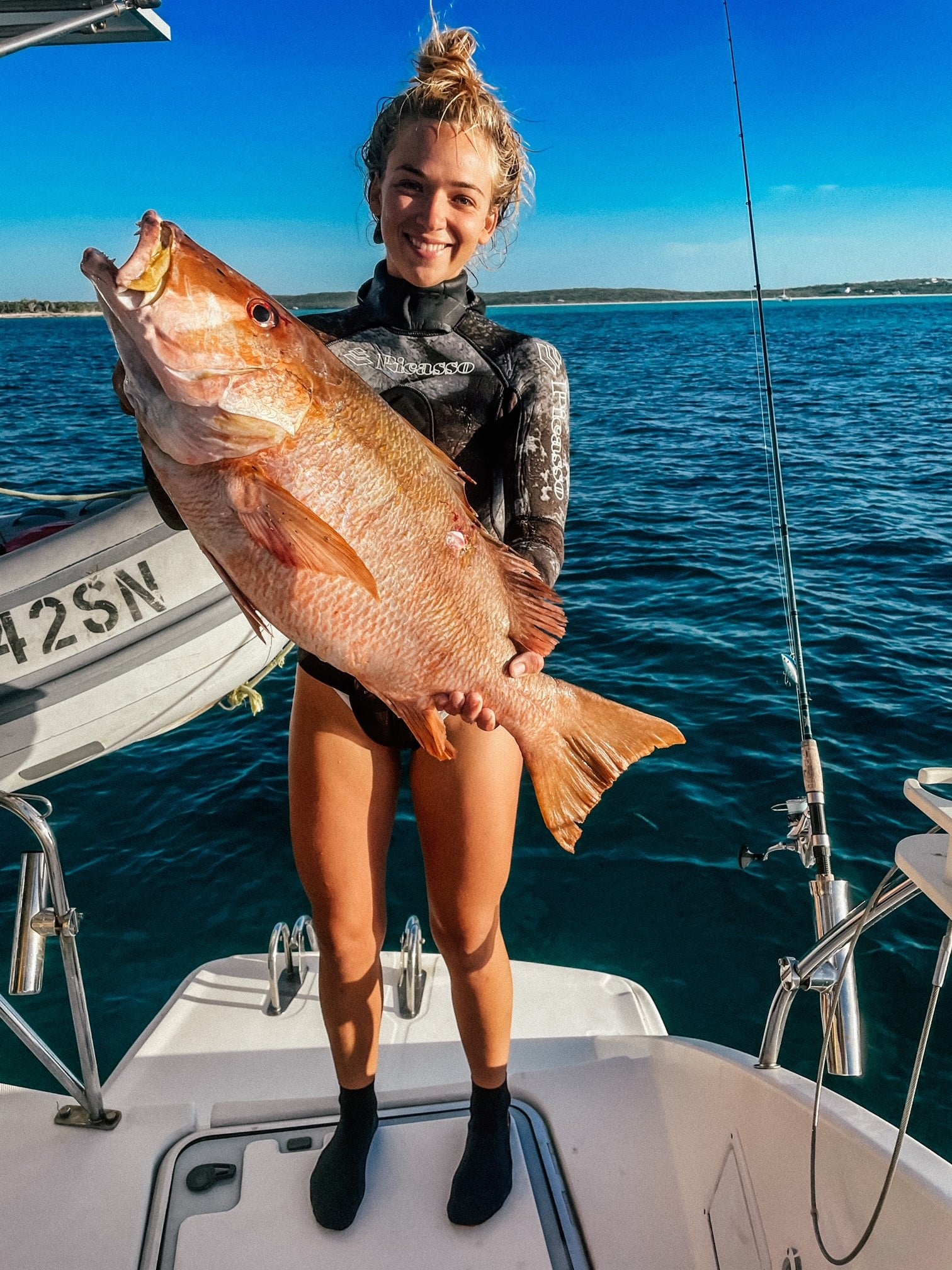 Sascha Meyers holding a large fish on a boat