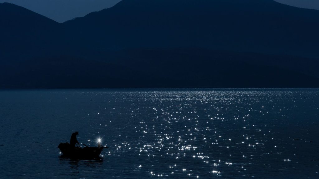 boat on open water during the nighttime