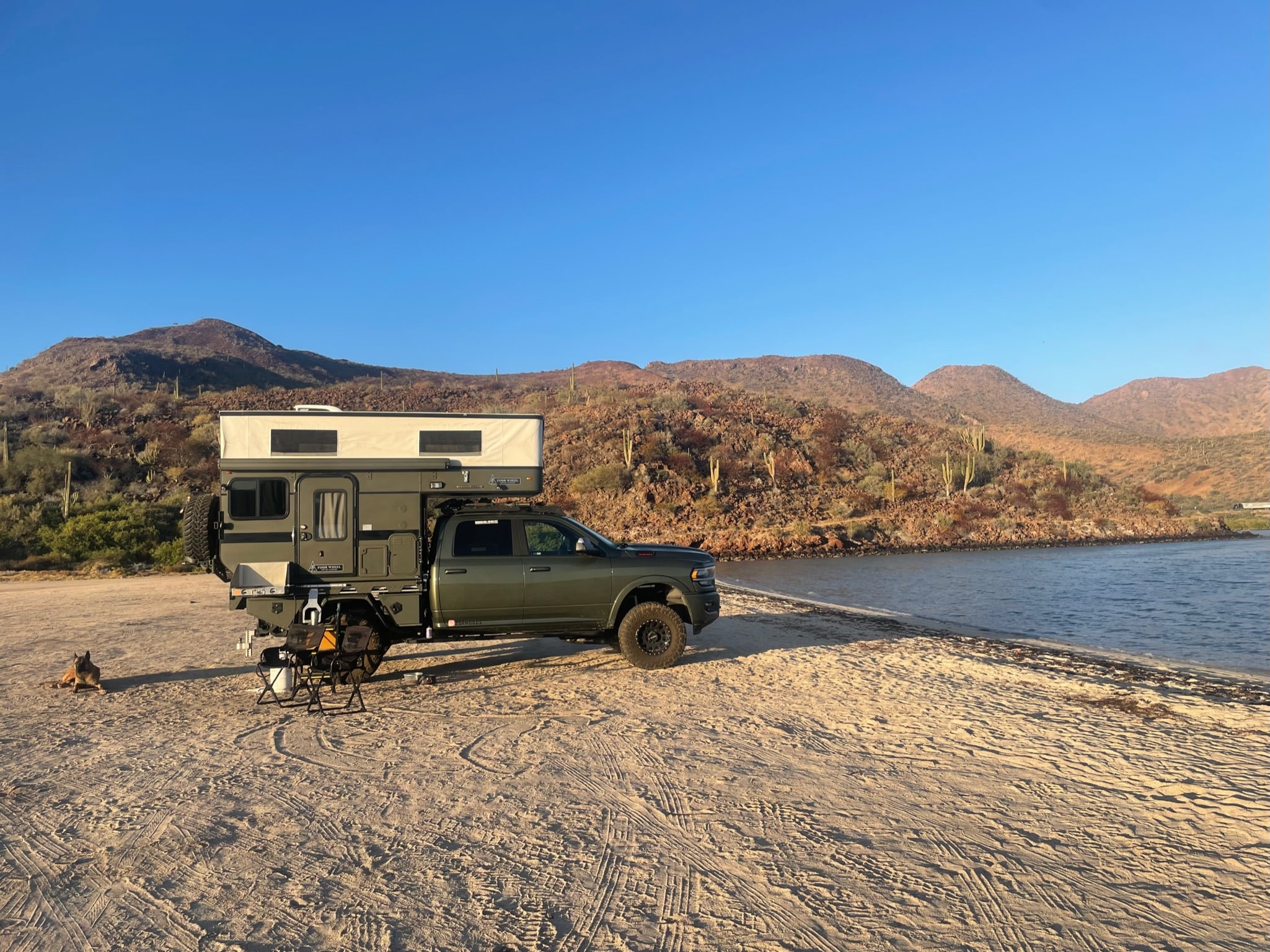 Sean Silvera Truck parked on the beach of a lake with cacti in the back