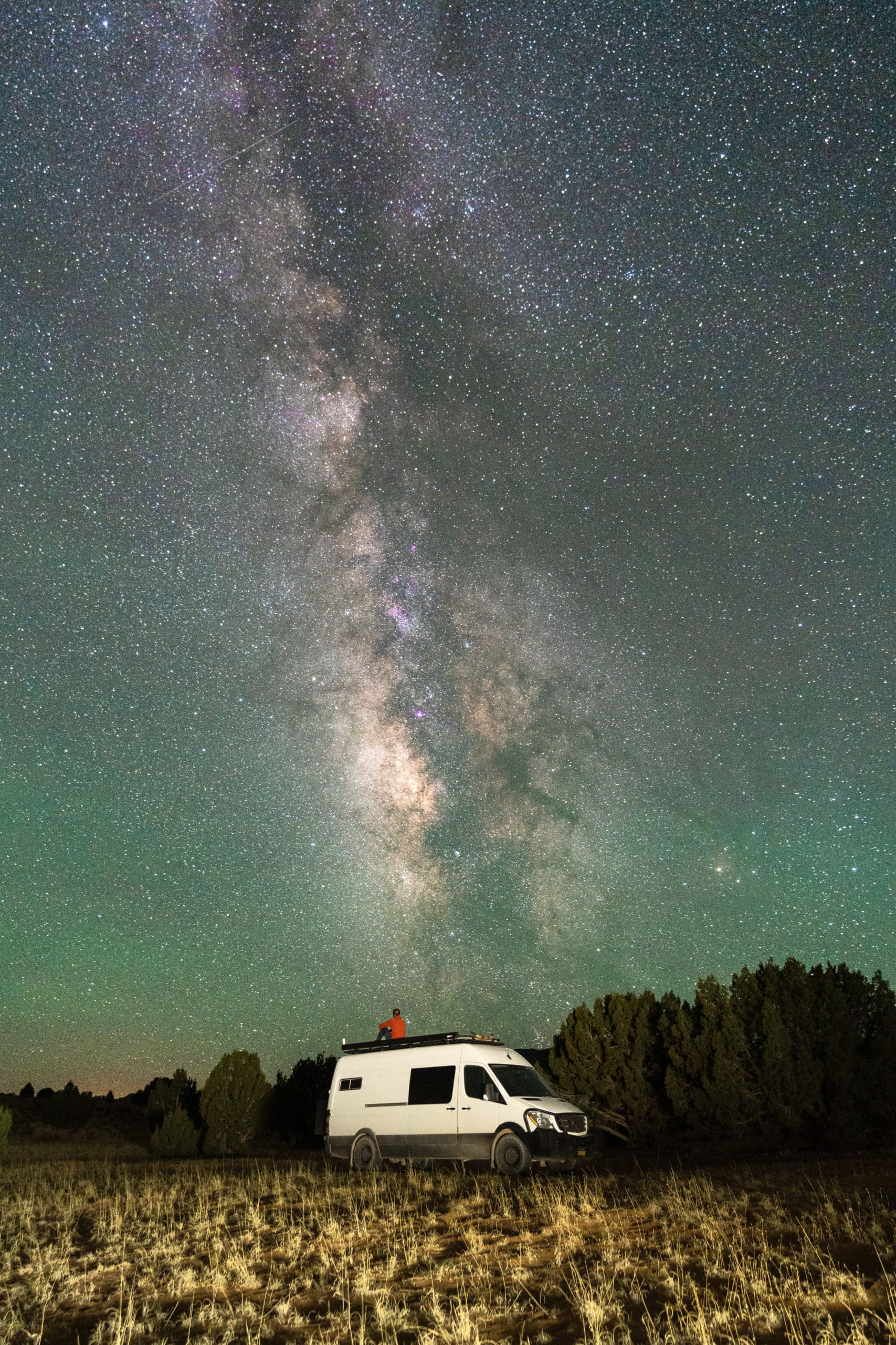 Desert Cruisers in Their Van Under the Milky Way