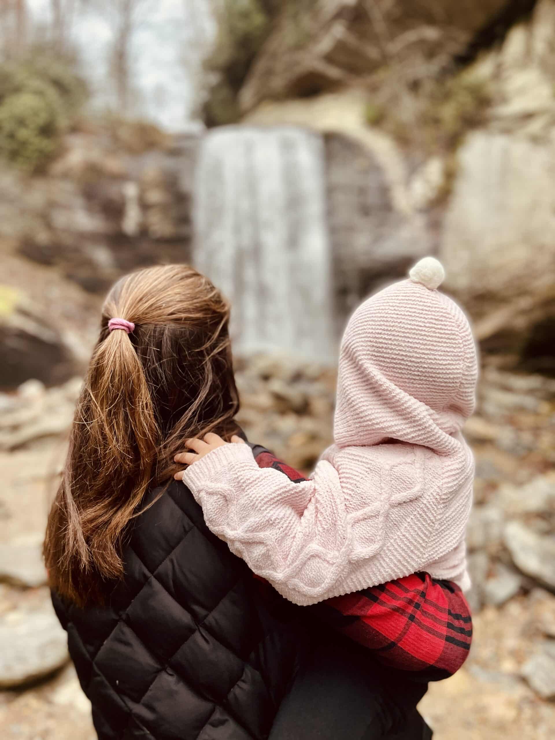 Mom and Daughter in Front of a Waterfall