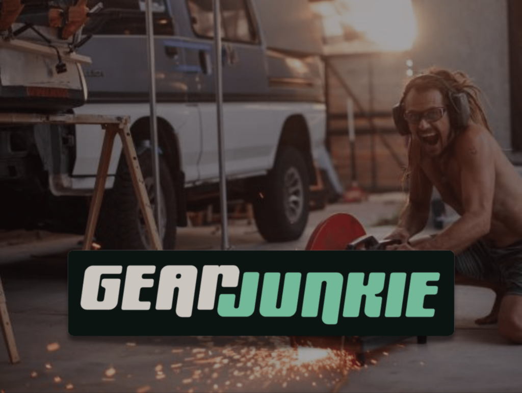 Gear Junkie Graphic Over Man Working on Truck Using a Power Saw
