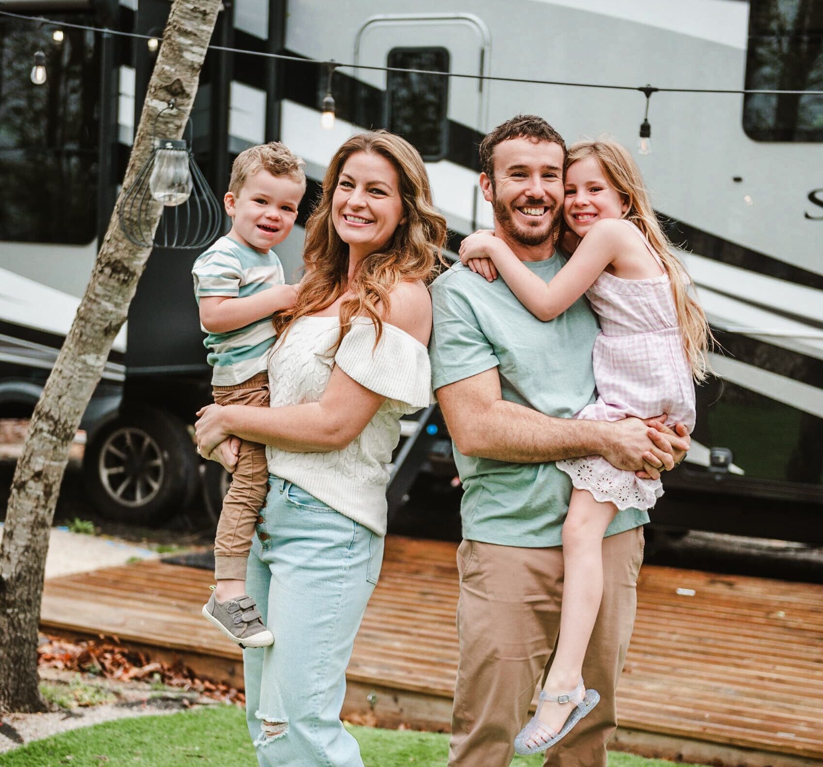Less Junk More Journey family photo outside of their Solitude RV