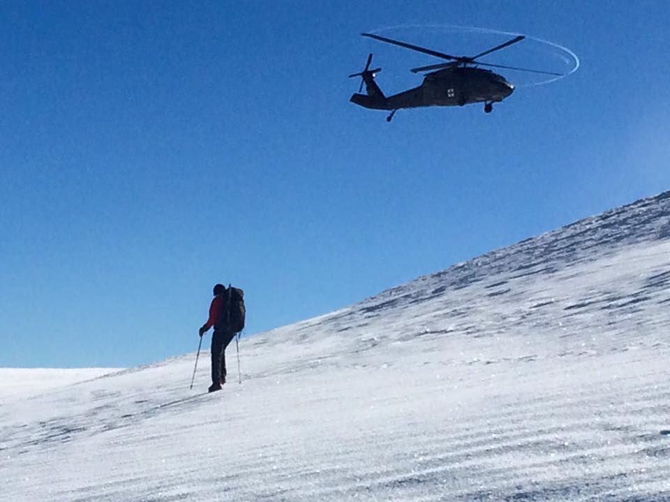 helicopter over a man on a mountain