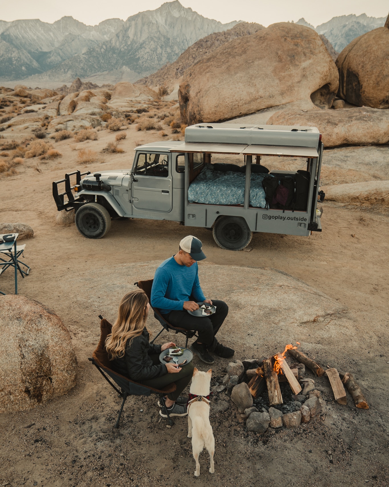 Go Play Outside at a campfire next to their Land Cruiser