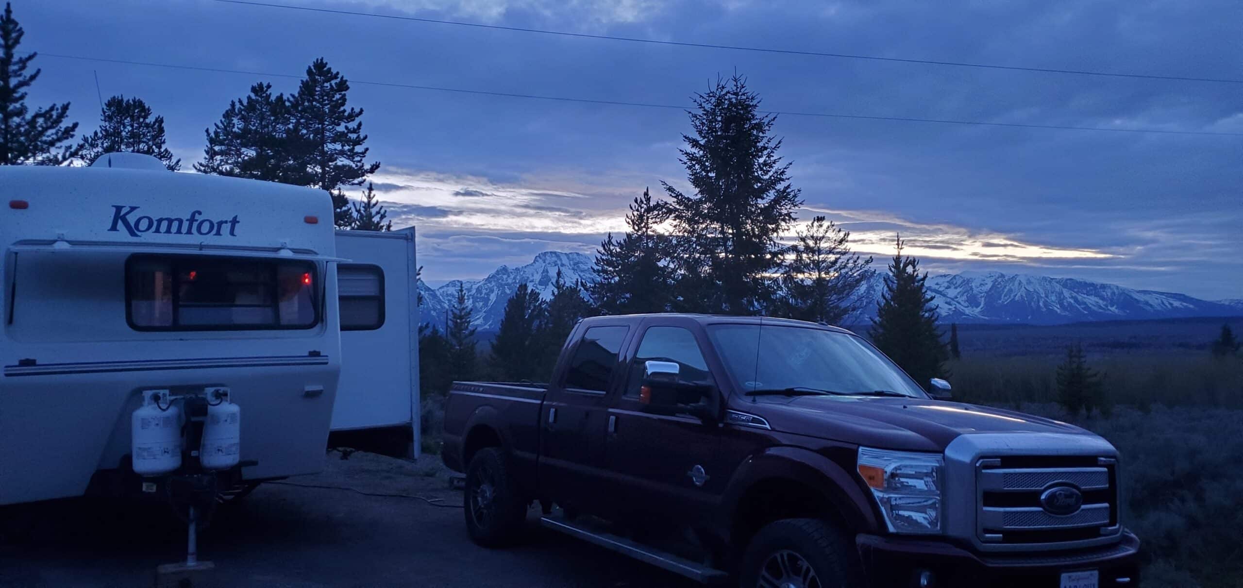 Truck and Trailer parked with snowy mountains in the background