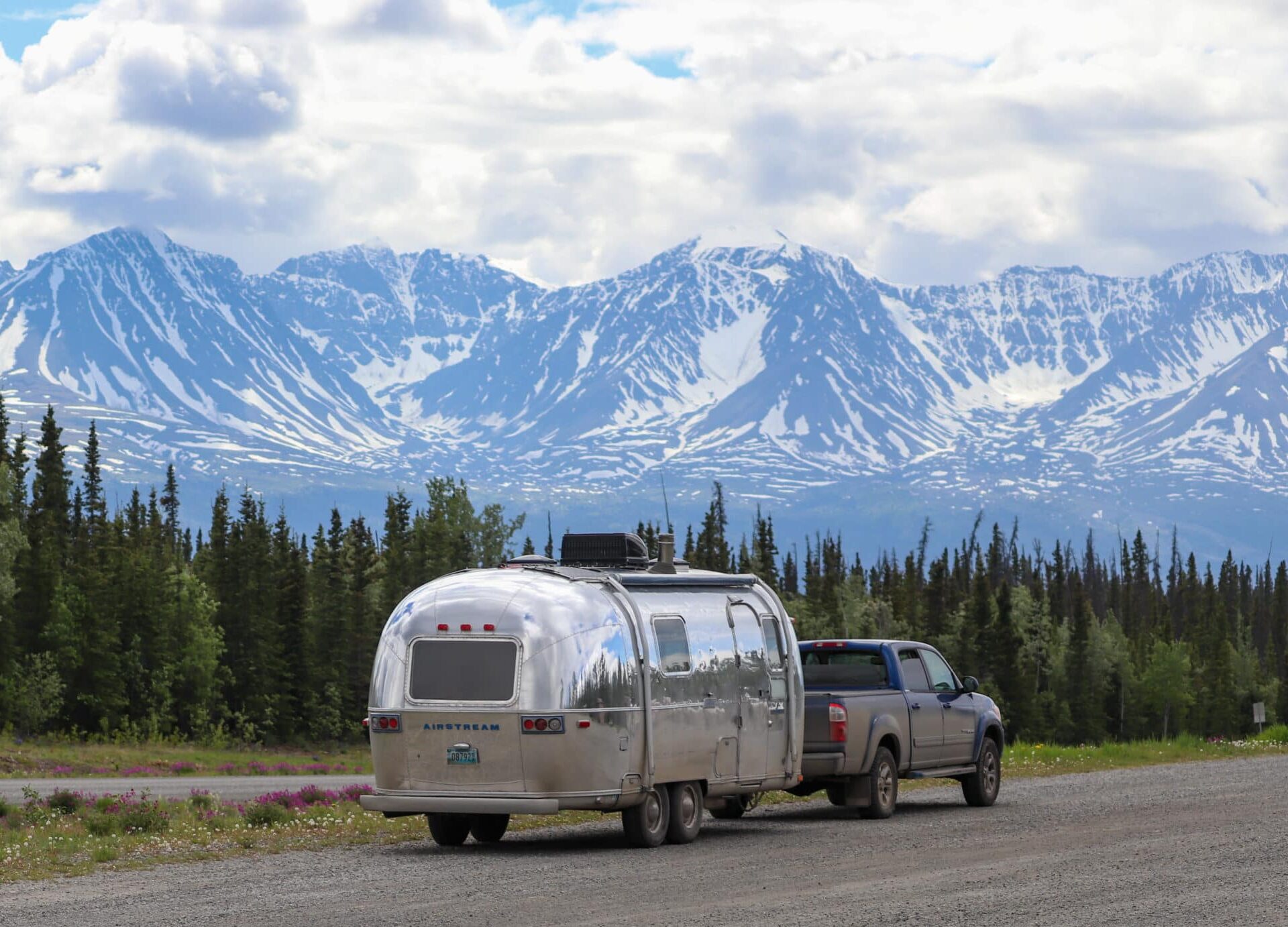 Slow Car Fast Home Airstream being towed in the mountains