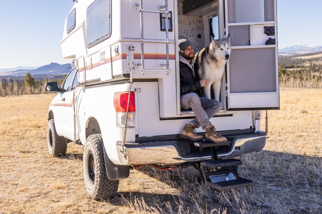 Kelly Lund and Loki the Wolfdog in Truck Camper