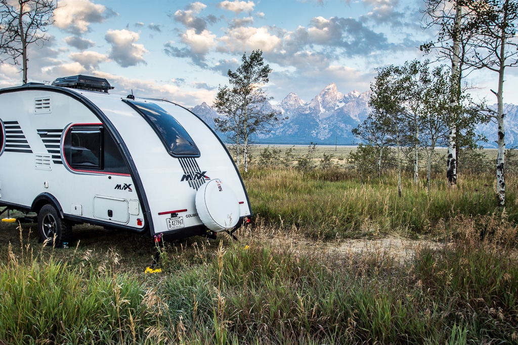 A camper is parked in a scenic boondocking site in the mountains