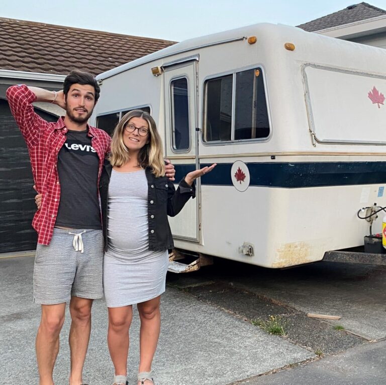 Levi Hildebrand and wife Leah in front of their trailer