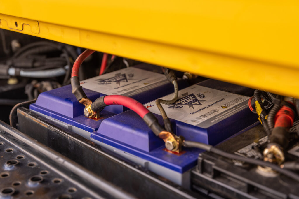 Lead acid battery attached to a trickle charger next to Battle Born Batteirs