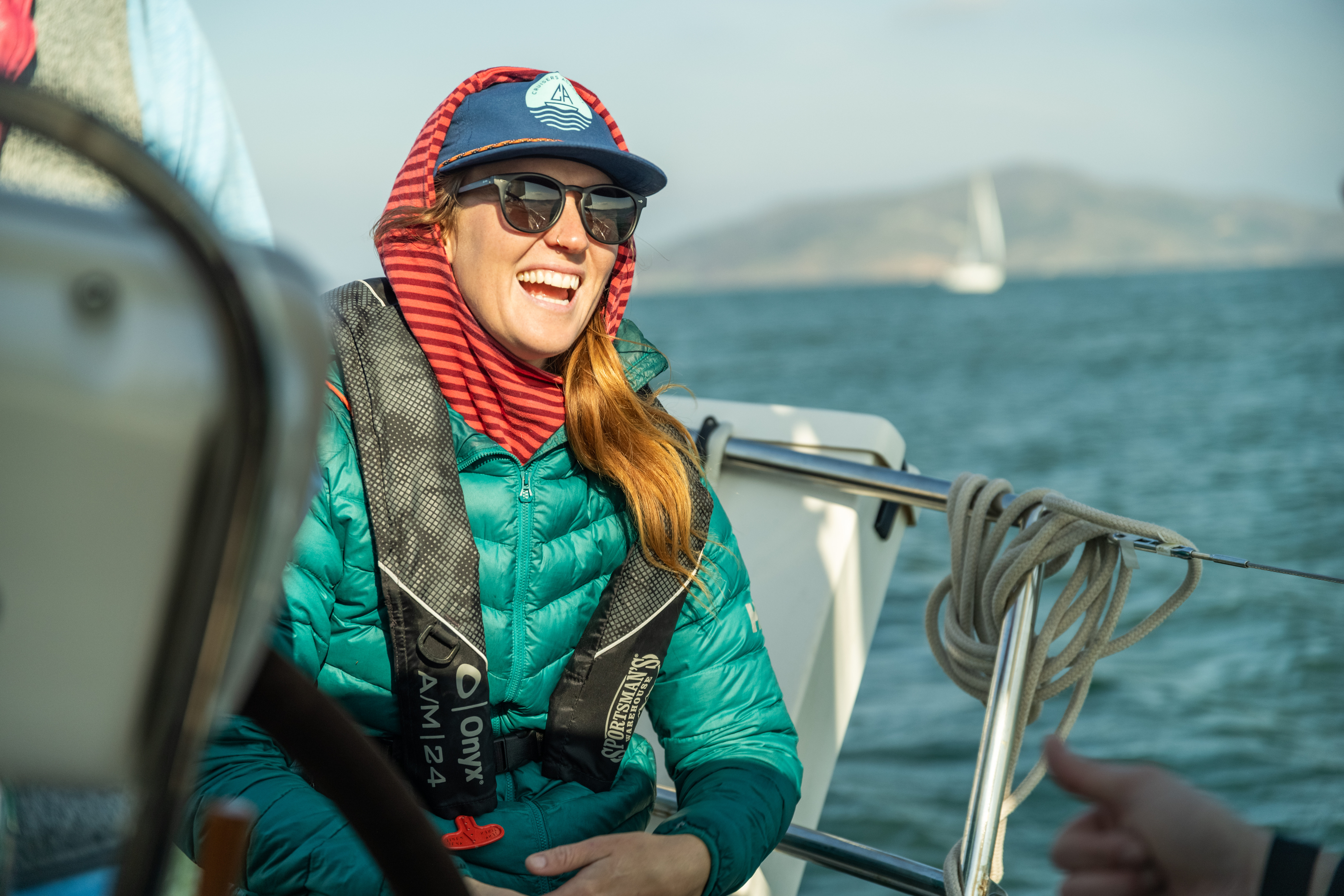 woman sailing wearing a personal flotation device