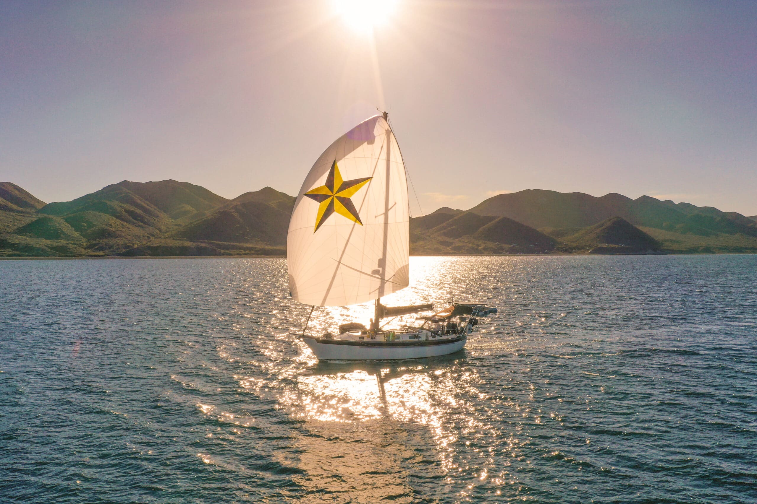 Sailboat with the sun shining through the sail