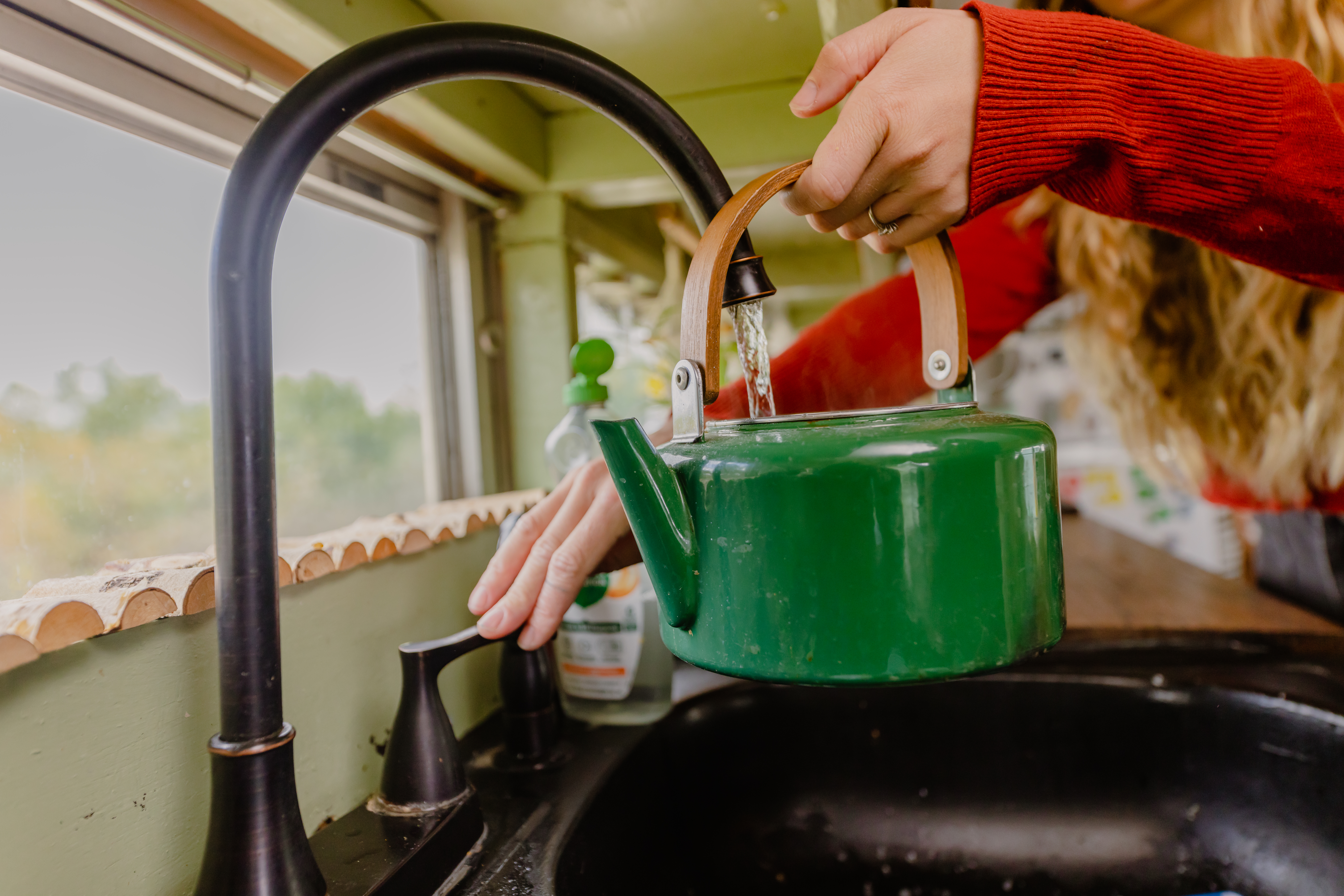 Tea kettle being filled up 